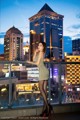 A woman in a short dress standing on a balcony.