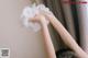 A woman cleaning a wall with a cloth.