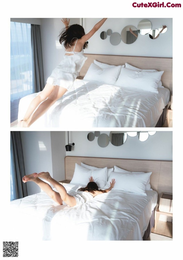 A woman jumping on a bed in a bedroom.