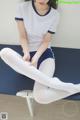 a woman sitting on top of a table with her legs crossed