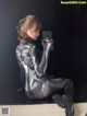 A woman in a black and silver spider suit taking a selfie.