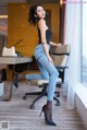 A woman sitting on a chair in a room.